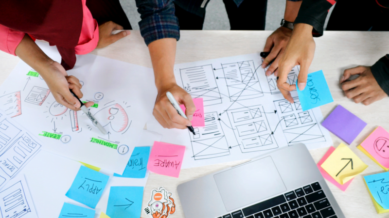team drawing web design concepts
