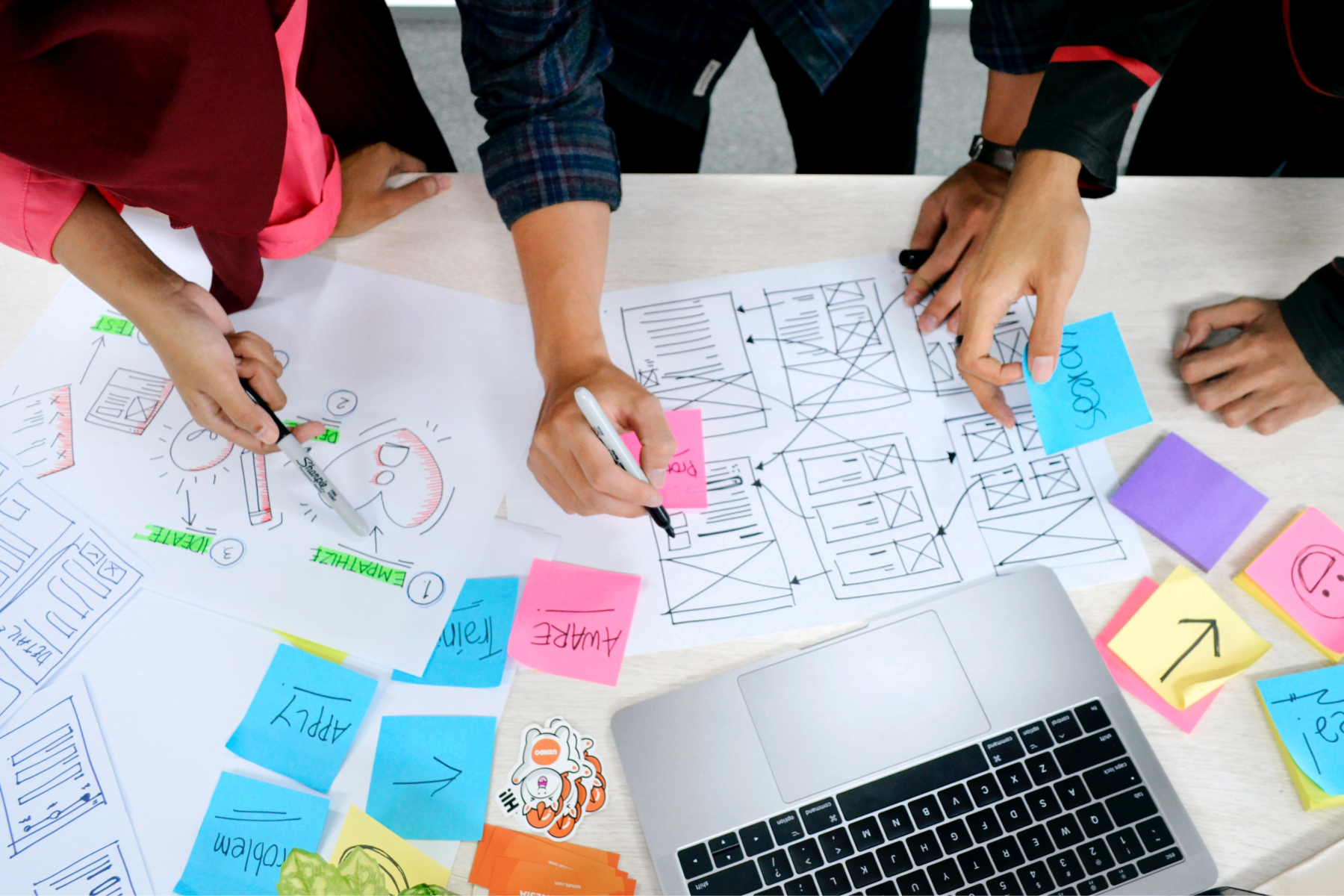 team drawing web design concepts